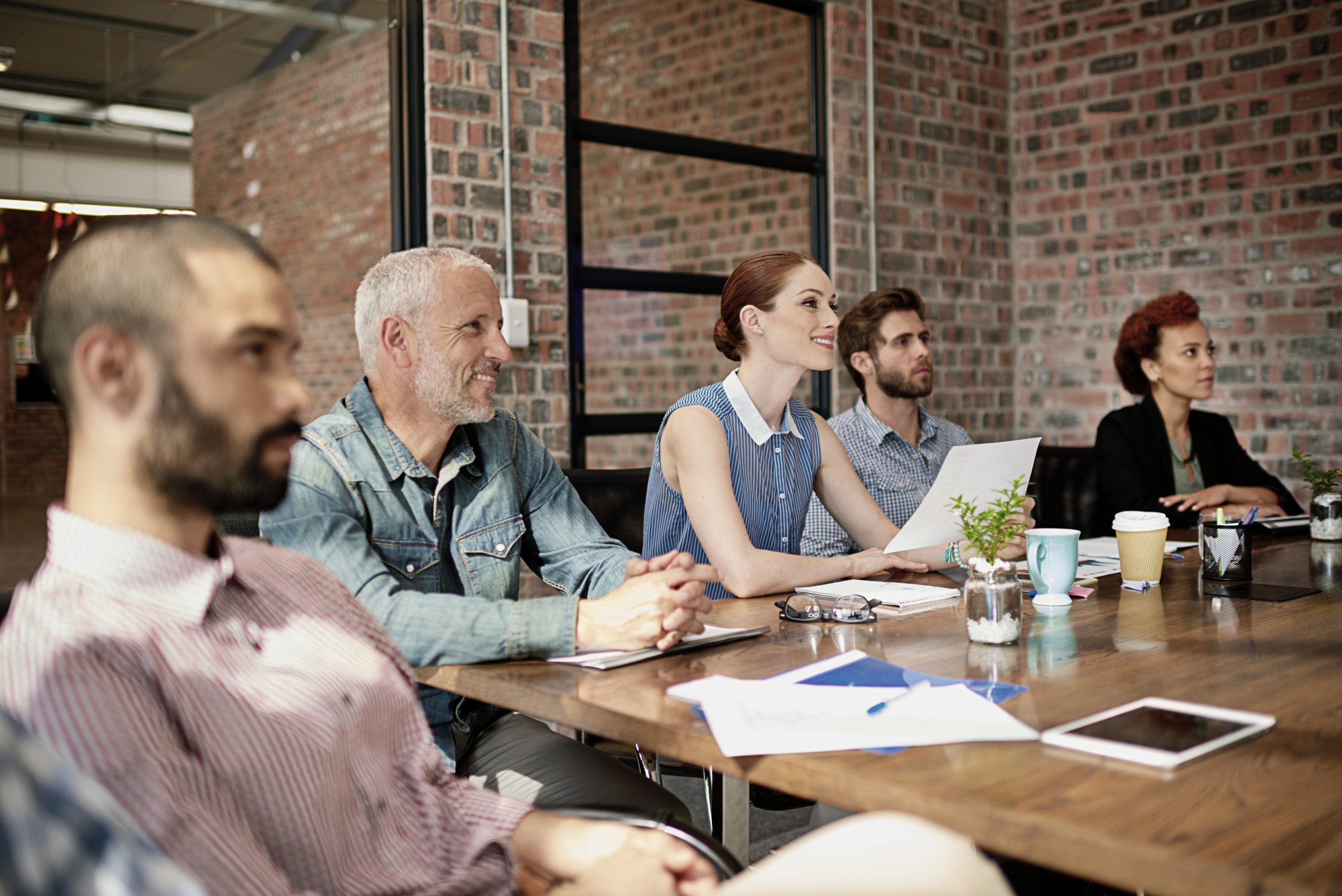 Business people listening to a presentation about NetSuite managed services